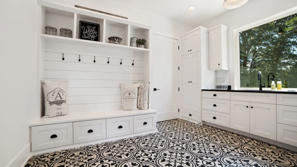 Kitchen and mudroom combo finished in shades of black and white