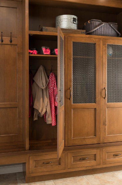Mudroom closet space complete with hooks, handles and mesh screen door inserts.