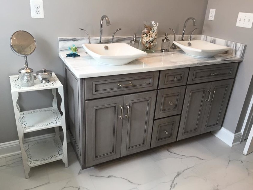 Gray themed bathroom with silver faucets and hardware