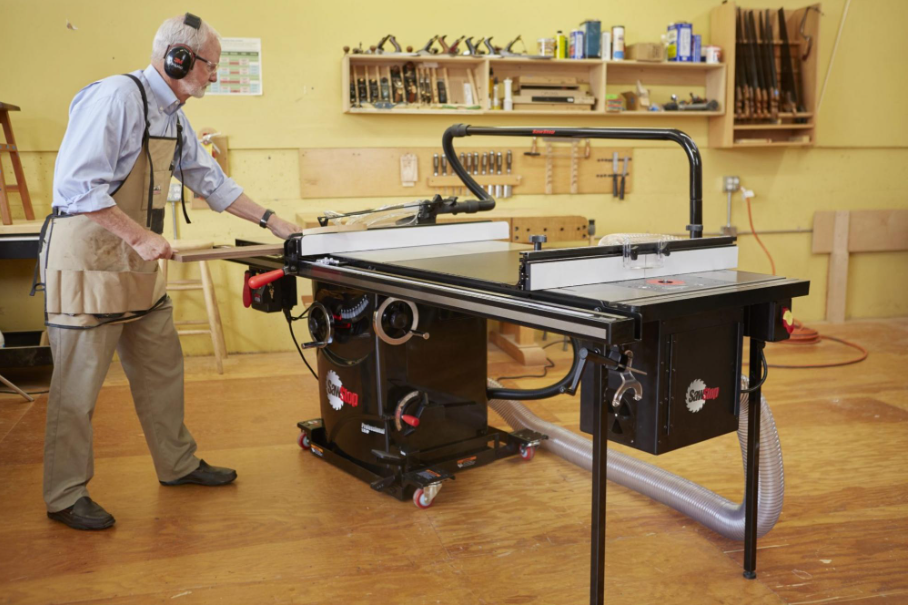 Older man cutting wood with a SawStop table saw.