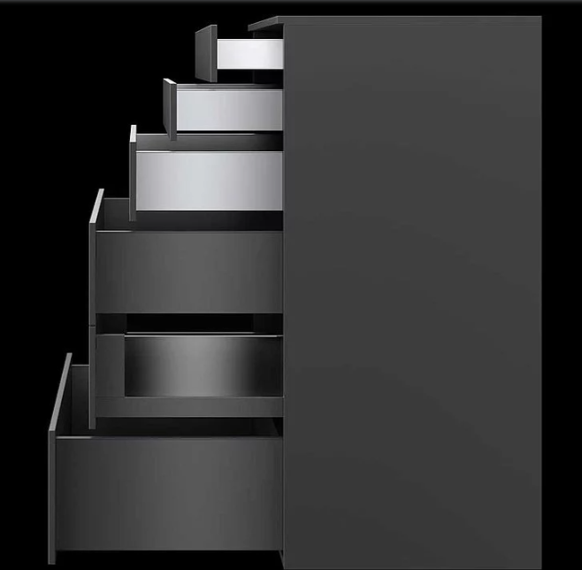 Gray filing cabinet with multiple open drawers extending to the left against a black background showing metal slides and fronts