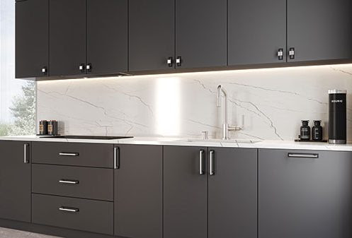Statler Woodworker Express Blog Modern dark gray kitchen with a marble backsplash under cabinet lighting and a stainless steel sink along a long counter