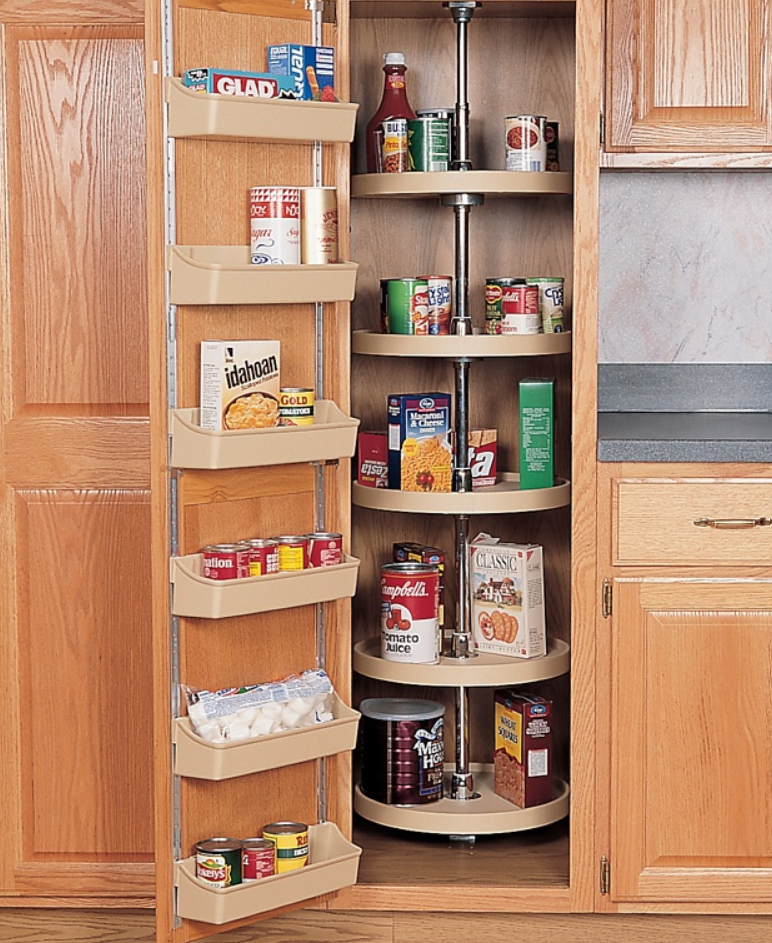 A tall kitchen cabinet with a rotating circular shelf filled with canned foods and boxes visible inside a pantry